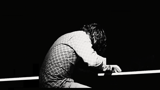 Person playing piano in black and white