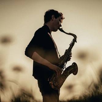 photo of Matt Carmichael playing a saxophone